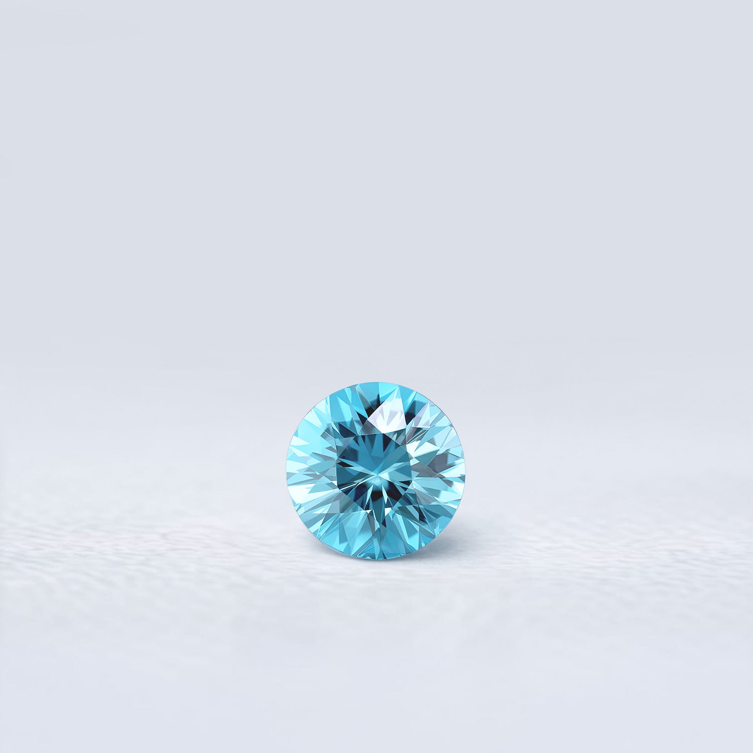 Zircon bleu naturel rond de 1.26 carat facetté, couleur cyan prononcé, originaire du Cambodge