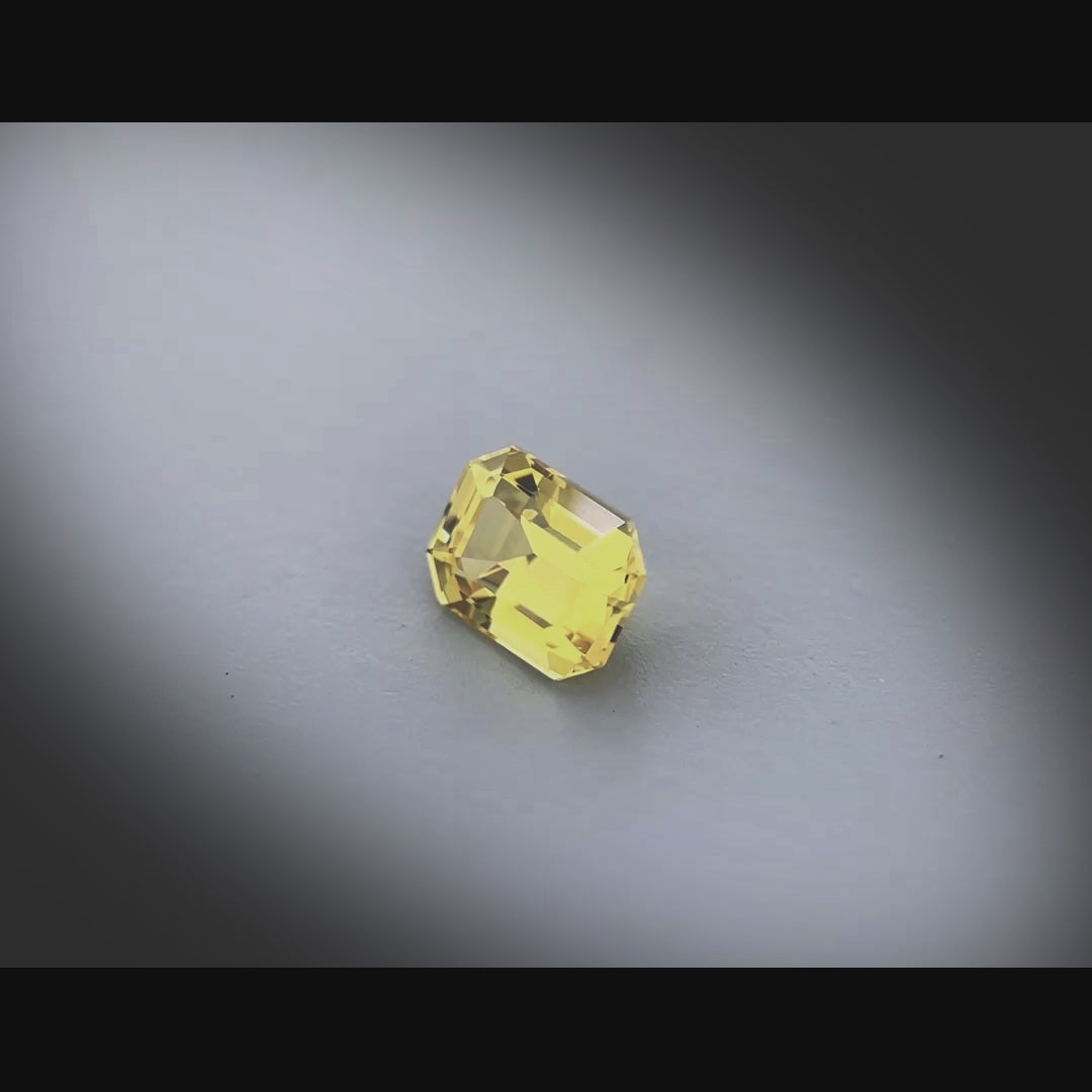Vidéo d’un saphir naturel jaune-vert rectangulaire à pans coupés de 1.27 ct, facetté et sans inclusion visible, tournant à 360 degrés sur fond gris clair