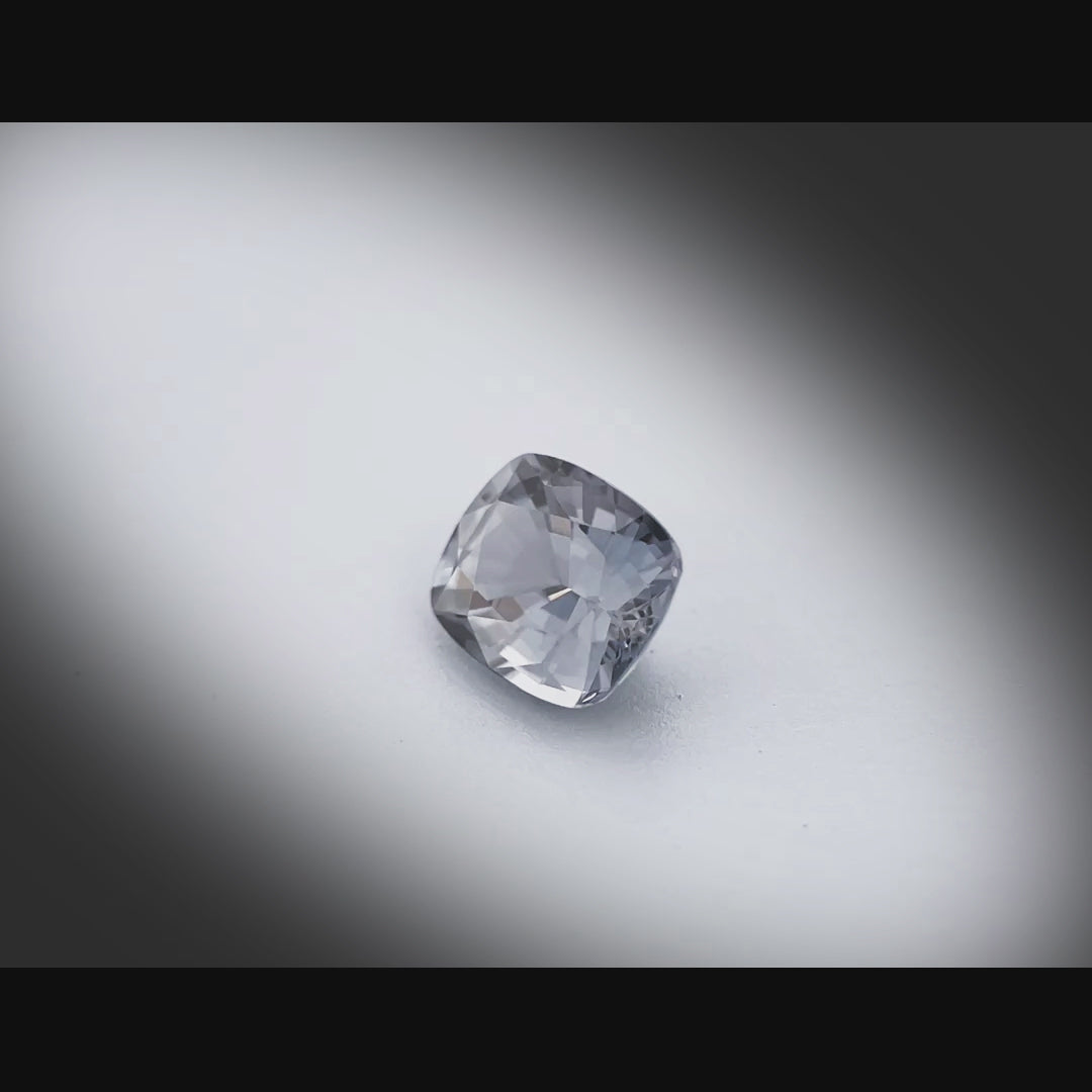 Vidéo d’un spinelle gris naturel coussin facetté de 1.19 ct, originaire du Myanmar, de couleur gris soutenu, tournant à 360 degrés sur fond gris clair