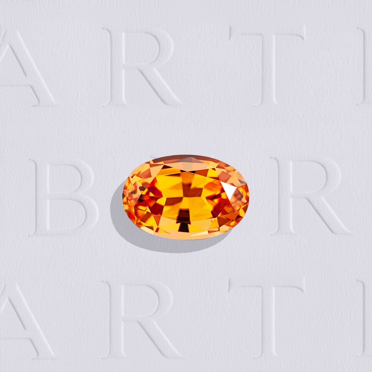 Grenat Spessartite naturel ovale facetté de 0.68 carat, originaire du Nigéria, de couleur orange soutenu, sans inclusion visible à l’œil nu. Aucun traitement.