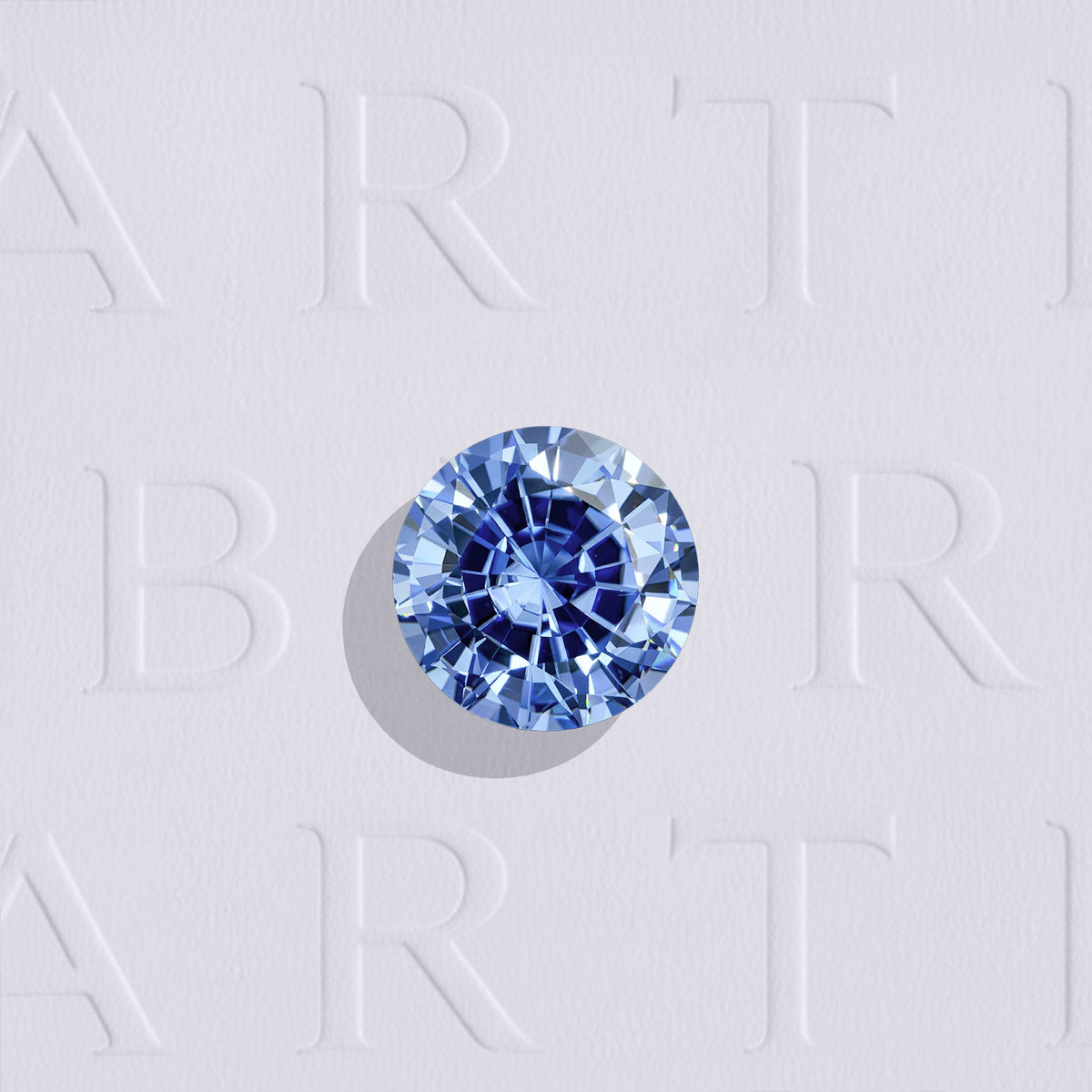 Saphir bleu naturel rond facetté de 0.59 carat, originaire du Sri Lanka, de couleur bleu prononcé, légèrement inclus et chauffé.